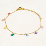 Rainbow pride bracelet featuring droplets with colours from the rainbow pride flag, wide