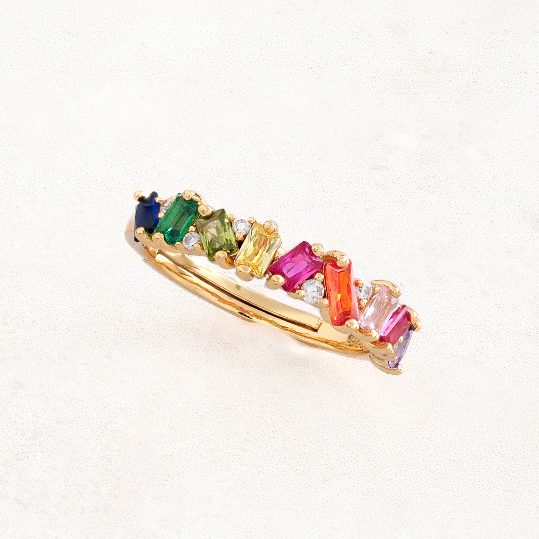rainbow pride ring with collision design featuring stones with rainbow pride flag colours, angled