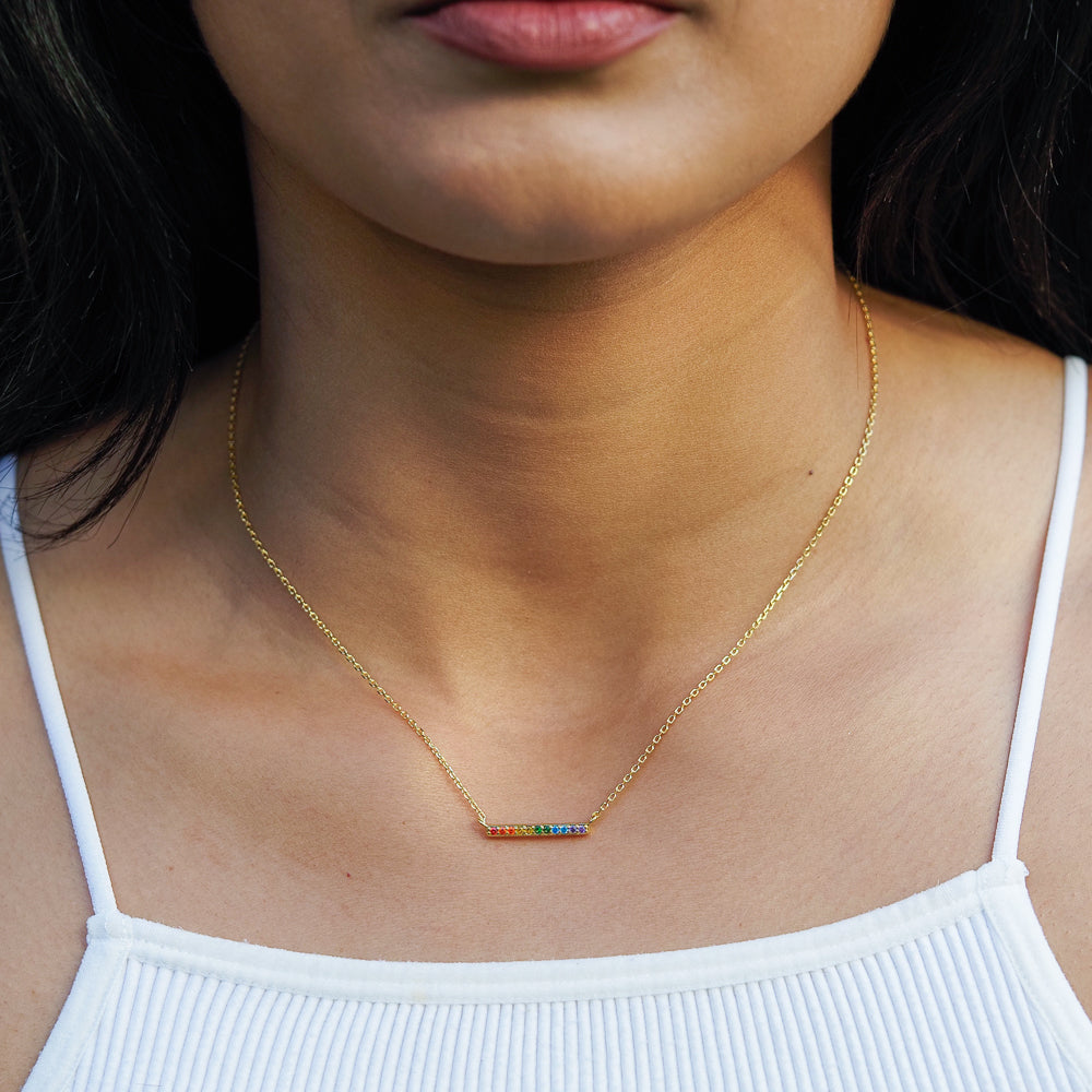 Rainbow necklace with line style and rainbow pride flag design on model