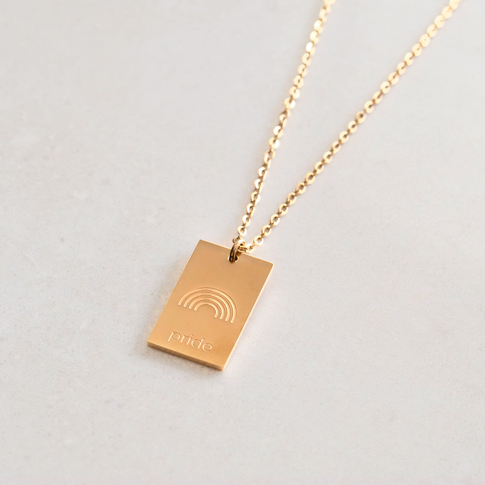 pride tag necklace with rainbow symbol and pride text in pride jewellery collection, gold side
