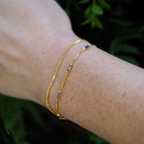purple and gold bracelet, wear it purple day, pride jewelry, model